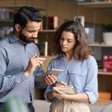 Employees accessing an intranet in a retail store | Intranet vs. SharePoint