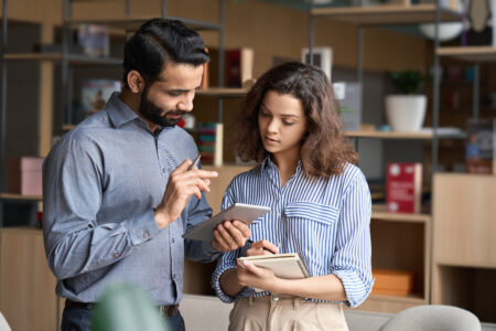 Employees accessing an intranet in a retail store | Intranet vs. SharePoint