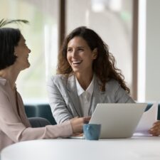 Two engaged employees working on a laptop | Intranet vs. internet