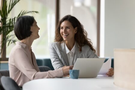 Two engaged employees working on a laptop | Intranet vs. internet