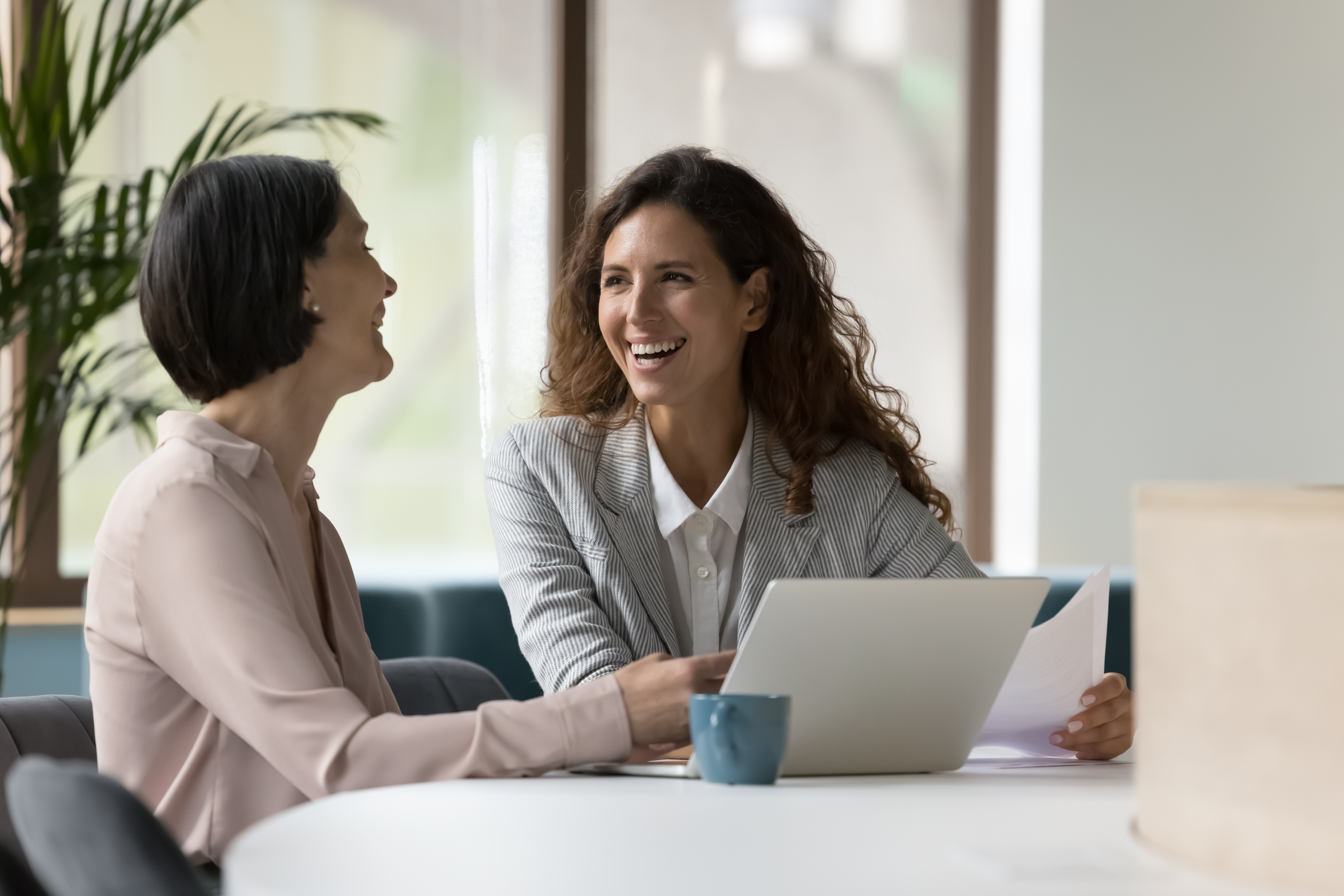 Two engaged employees working on a laptop | Intranet vs. internet