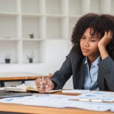 A disengaged employee working at a desk | How to prevent social loafing