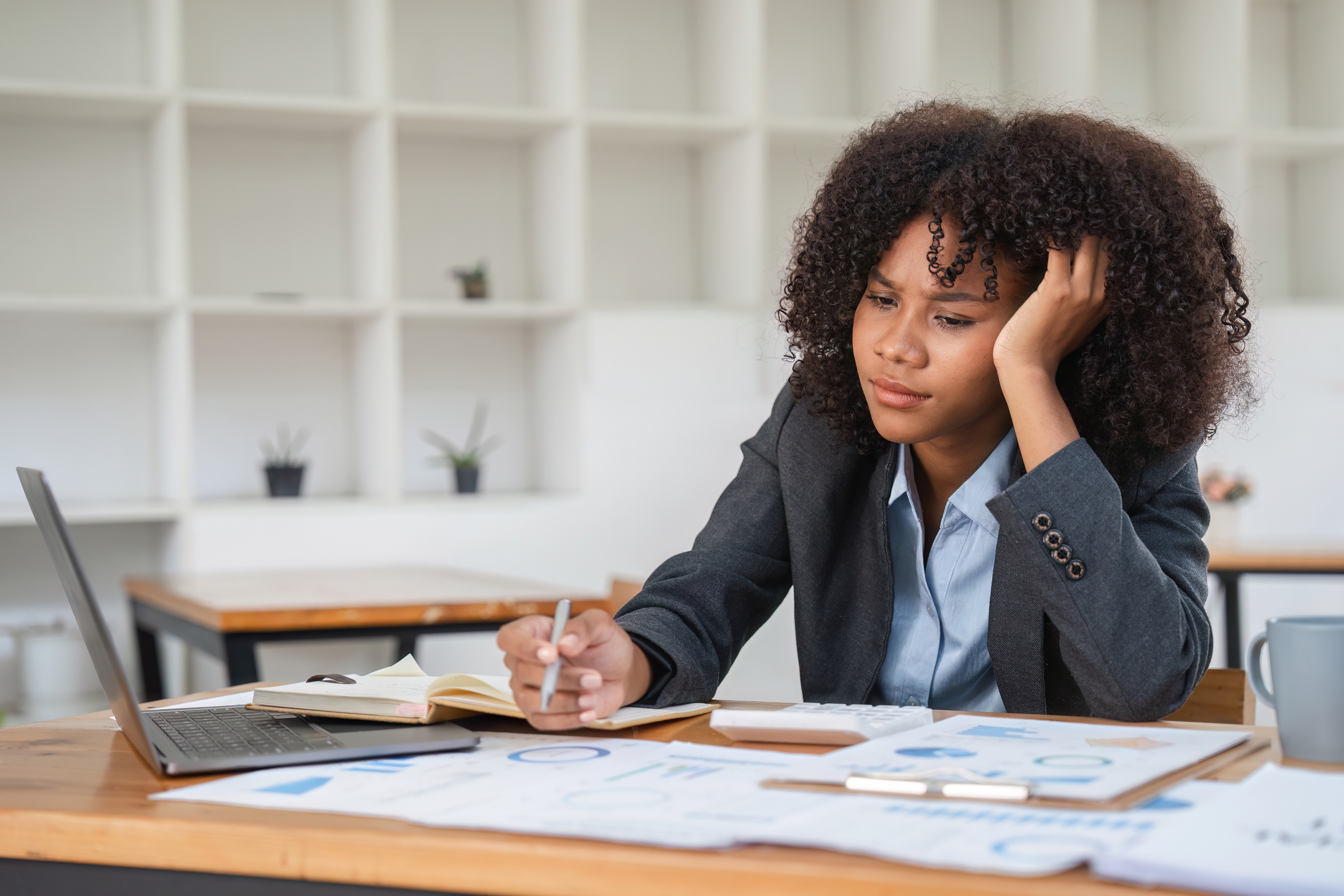 A disengaged employee working at a desk | How to prevent social loafing